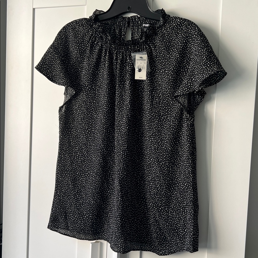Express short sleeve flowy shirt. Black with white dots. Tags on